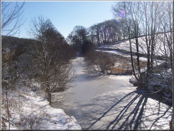 The frozen river Washburn as it approaches Fewston reservoir