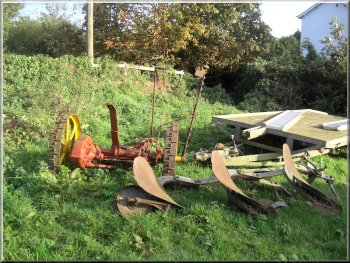 A plough and an old hay cutter