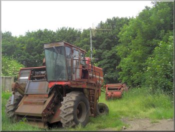 Old combined harvester  serving as a TV aerial stand
