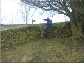 Stile on to the road above Padside Beck