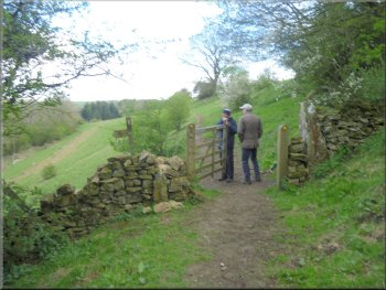 Path contouring round the hillside to a gate in the wall