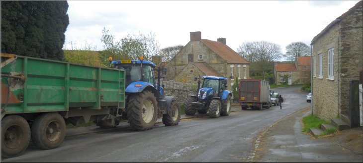 Farm vehicles parked along the road in Lockton