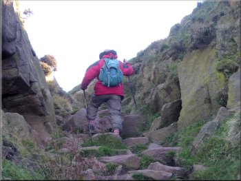 Climbing through a cleft in the rocks onto the ridge