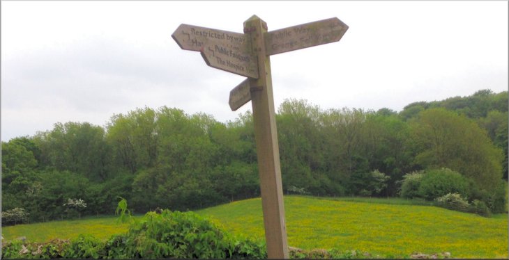 Sign post where the path from Eggerslack Wood joins the access road from High Farm