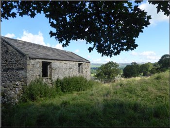 Old stone barn as we came out of the trees to the field path