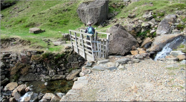 Crossing the footbridge over Levers Water beck at map ref. SD 283 988