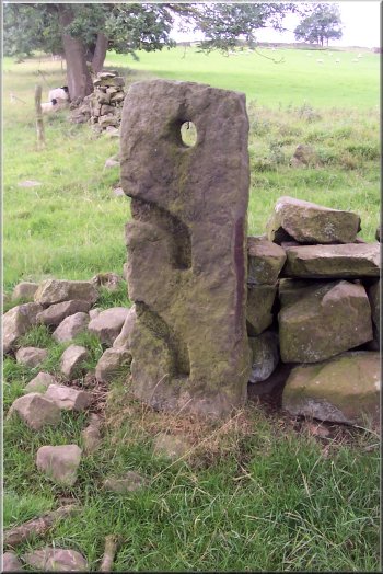 Stone gate post with carved recesses for the poles that made up the gate