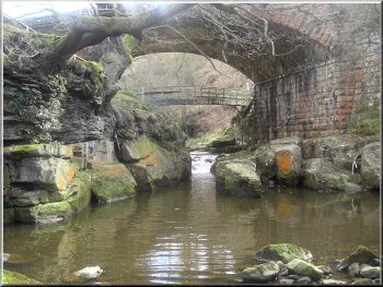 Narrow rocky channel for the beck below the railway bridge