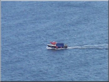 One of the many small boats moving along the coast