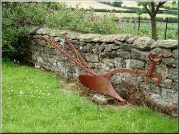An old horse drawn plough used as a garden ornament