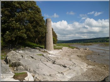 Tall chimney on the rocky shore
