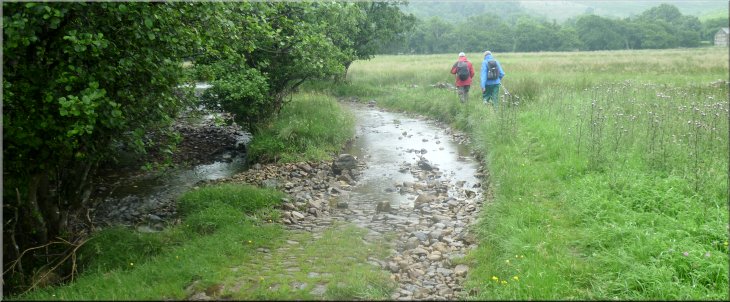 The beck on the left, flooded track on the right