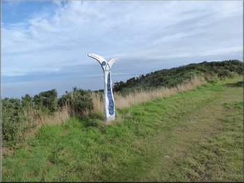 The ubiquitous Sustrans route marker on the cliff top