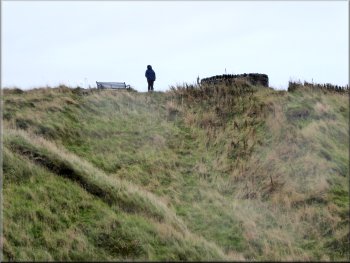 My wife waiting on the cold, wet, windy cliff top path
