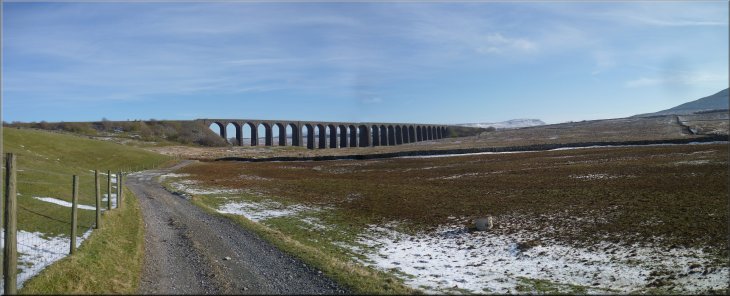Ribblehead Viaduct with Pen-y-Ghent at the right hand end seen from the track at Gunnerfleet farm
