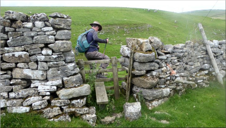 Crossing the stile to drop down to Heber Beck
