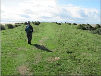 Following a grassy track along the headland