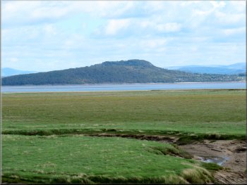 The wooded hill of Arnside Knott seen across the bay