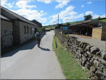 Passing the farm buildings on the access road at Studfold Farm